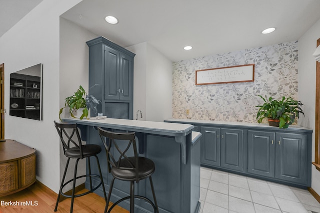 67 Dunmore Ct, Lenox, MA 01240 - kitchen featuring a breakfast bar, a peninsula, recessed lighting, and light tile patterned flooring