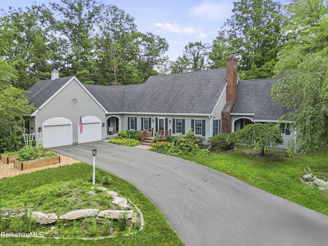 67 Dunmore Ct, Lenox, MA 01240 - view of front facade featuring driveway, an attached garage, a chimney, and a front yard