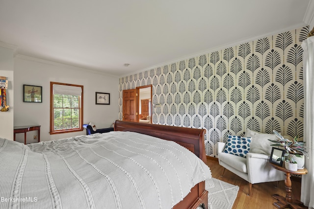 67 Dunmore Ct, Lenox, MA 01240 - bedroom with ornamental molding, wood finished floors, an accent wall, and wallpapered walls