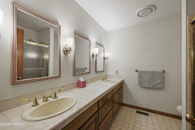 67 Dunmore Ct, Lenox, MA 01240 - bathroom featuring double vanity and a shower with door