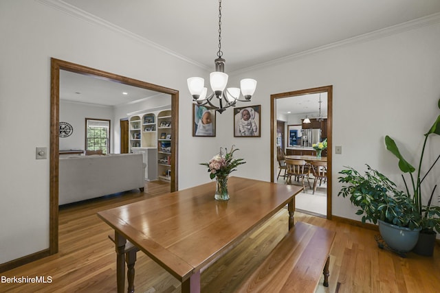 67 Dunmore Ct, Lenox, MA 01240 - dining room with a chandelier, ornamental molding, and wood finished floors