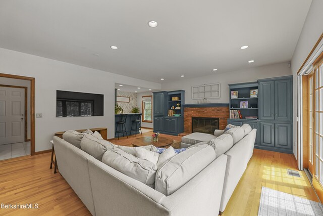 67 Dunmore Ct, Lenox, MA 01240 - living room with a brick fireplace, light wood-style floors, and recessed lighting