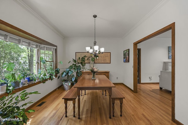 67 Dunmore Ct, Lenox, MA 01240 - dining space featuring light wood-style floors, a chandelier, and crown molding