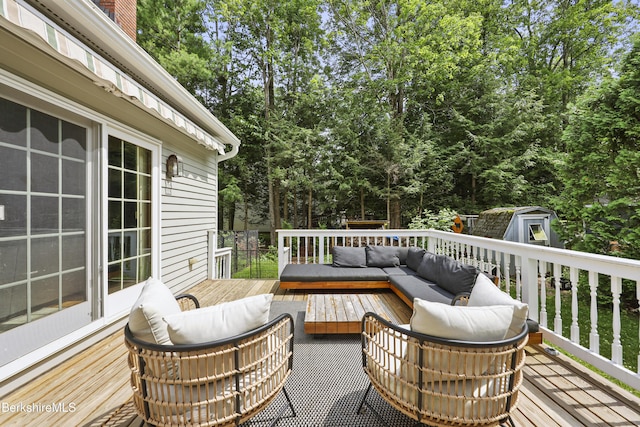 67 Dunmore Ct, Lenox, MA 01240 - wooden deck with outdoor lounge area, a storage shed, and view of wooded area
