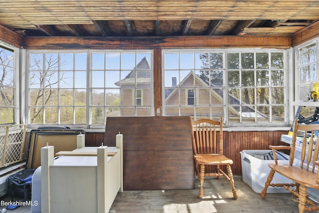 sunroom / solarium featuring wooden walls, wooden ceiling, and hardwood / wood-style flooring
