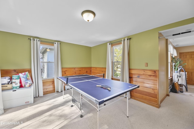 playroom featuring a healthy amount of sunlight, wood walls, wainscoting, and carpet flooring