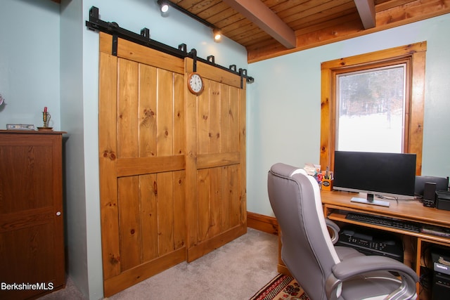 office with light carpet, wood ceiling, a barn door, and beamed ceiling