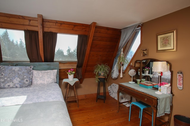 bedroom featuring multiple windows and hardwood / wood-style floors