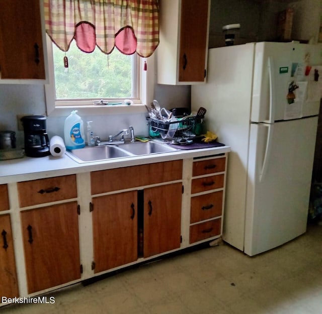 kitchen featuring white fridge and sink