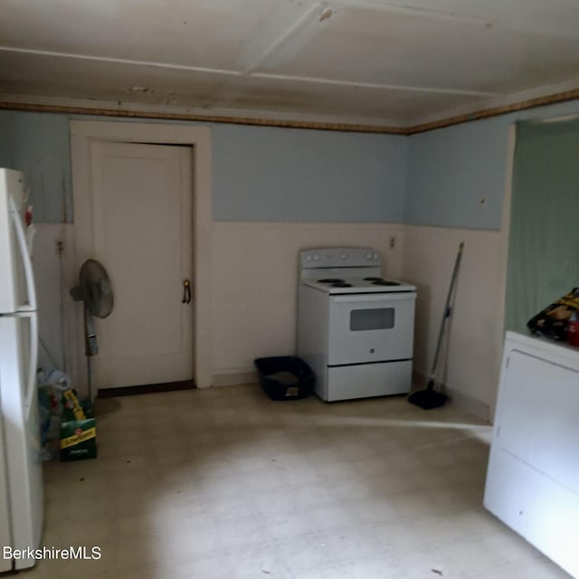 kitchen with white appliances and washer / clothes dryer