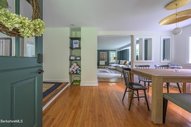 dining room with baseboards and wood finished floors