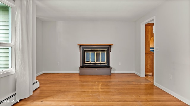 33 Quirico Dr, Pittsfield, MA 01201 - unfurnished living room featuring a baseboard heating unit, a glass covered fireplace, and light wood finished floors