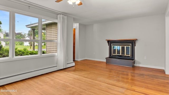 33 Quirico Dr, Pittsfield, MA 01201 - unfurnished living room featuring baseboard heating, a glass covered fireplace, wood finished floors, and a ceiling fan