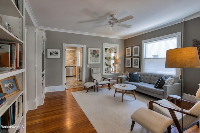 living area with crown molding, a ceiling fan, and dark wood-style flooring
