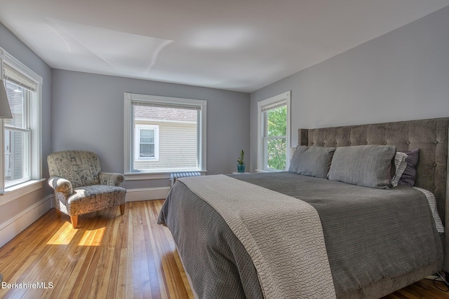 bedroom featuring wood-type flooring and baseboards