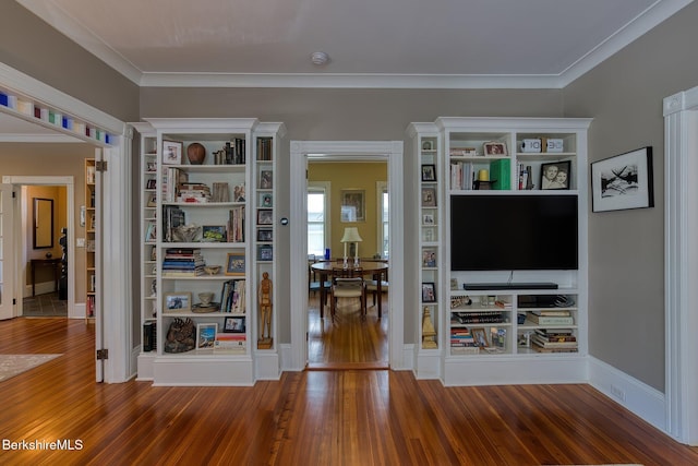 living area with wood-type flooring and ornamental molding
