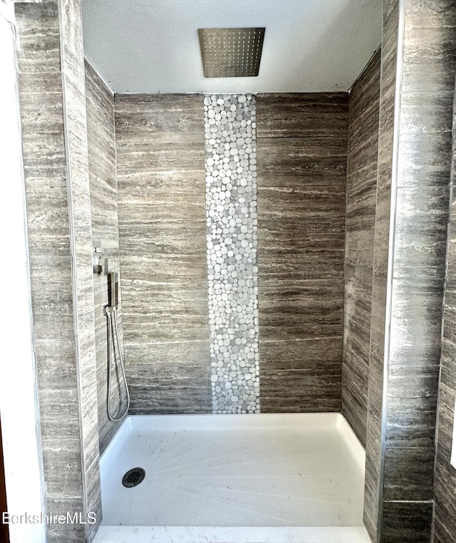 bathroom with tiled shower