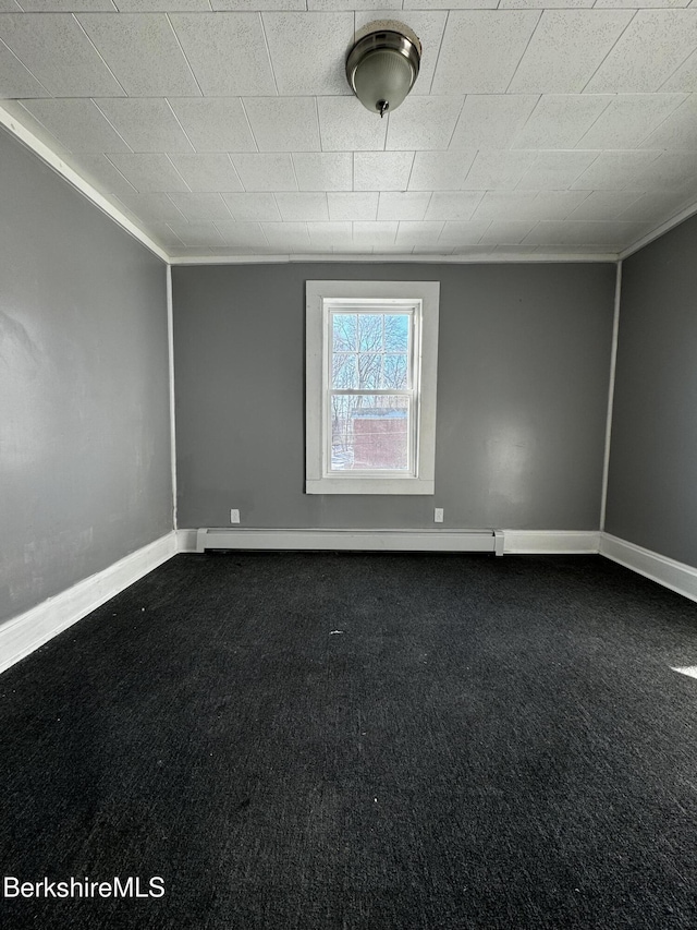 carpeted spare room with baseboard heating