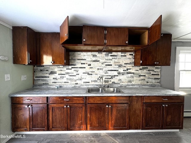 kitchen with tasteful backsplash, sink, and a baseboard radiator