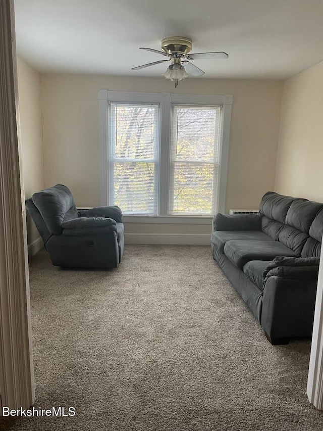 carpeted living room featuring ceiling fan