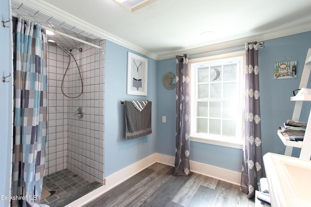 bathroom featuring a shower with shower curtain, plenty of natural light, crown molding, and hardwood / wood-style floors