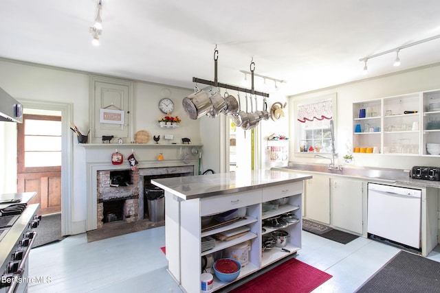 kitchen featuring a fireplace, a wealth of natural light, dishwasher, and white cabinets