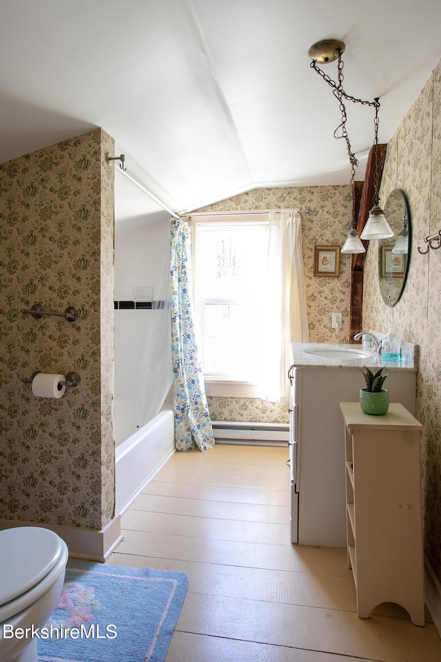 full bathroom with vanity, a baseboard heating unit, toilet, wood-type flooring, and shower / tub combo