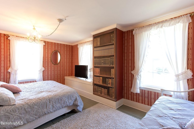 bedroom with a chandelier, multiple windows, and ornamental molding