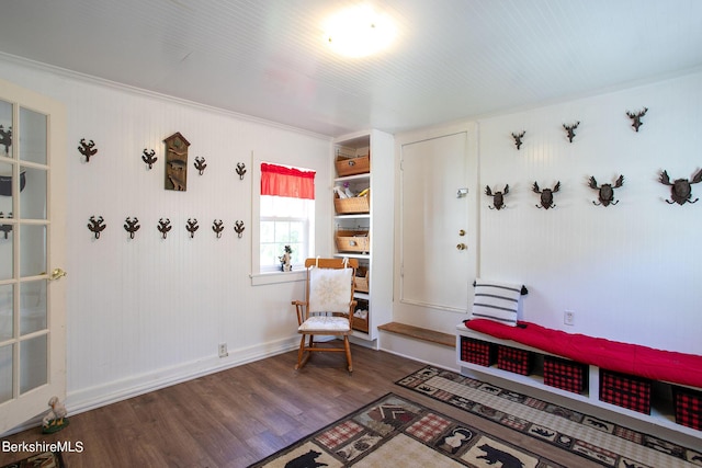 sitting room with crown molding and hardwood / wood-style flooring