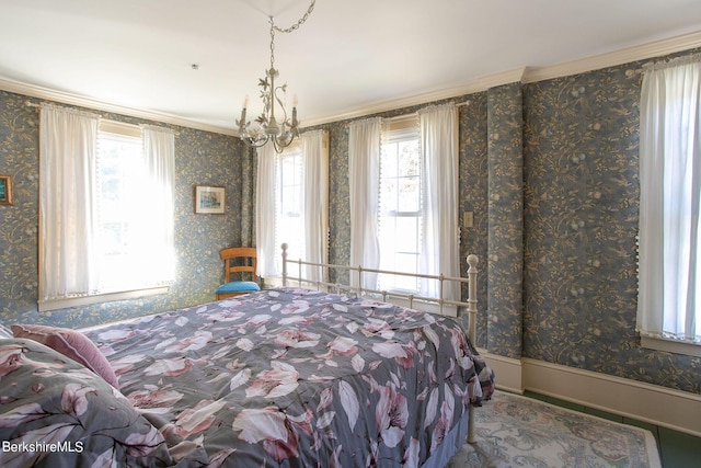 bedroom with multiple windows, a notable chandelier, and ornamental molding