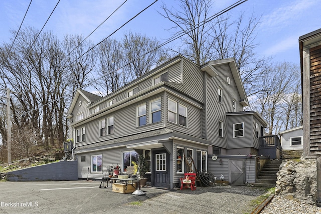 view of front of property featuring stairway