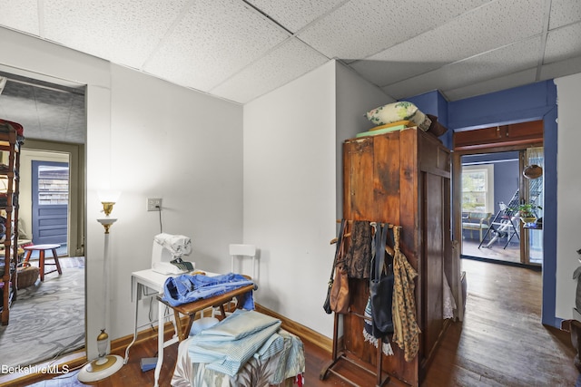 interior space with wood finished floors and a paneled ceiling