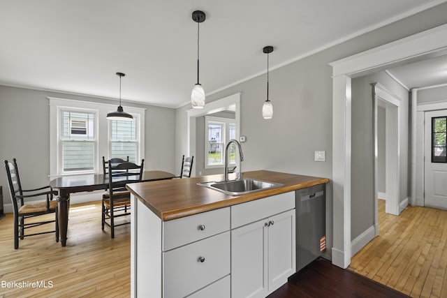 56 Perrine Ave, Pittsfield, MA 01201 - kitchen with wood counters, dishwasher, light wood-style flooring, white cabinets, and ornamental molding