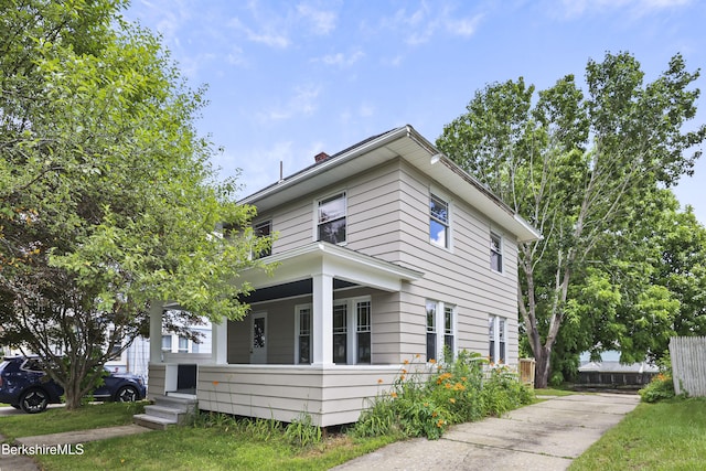 56 Perrine Ave, Pittsfield, MA 01201 - view of home's exterior with a porch, a chimney, and concrete driveway