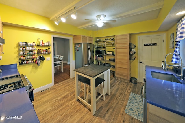 88 Newell St, Pittsfield, MA 01201 - kitchen with stainless steel appliances, track lighting, a ceiling fan, and wood finished floors