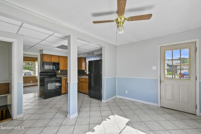 36 Dalton Division Rd, Dalton, MA 01226 - kitchen featuring black appliances, brown cabinetry, ceiling fan, baseboard heating, and wainscoting