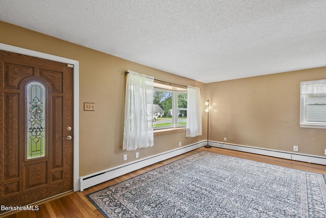 36 Dalton Division Rd, Dalton, MA 01226 - entrance foyer featuring wood finished floors, a baseboard radiator, and a textured ceiling