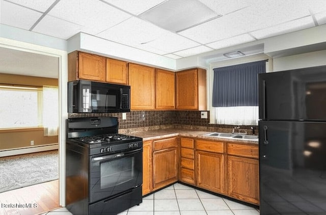 36 Dalton Division Rd, Dalton, MA 01226 - kitchen featuring black appliances, a baseboard radiator, a drop ceiling, brown cabinets, and tasteful backsplash