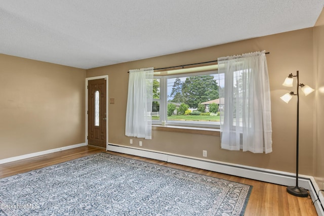36 Dalton Division Rd, Dalton, MA 01226 - foyer with a baseboard heating unit, wood finished floors, and a textured ceiling