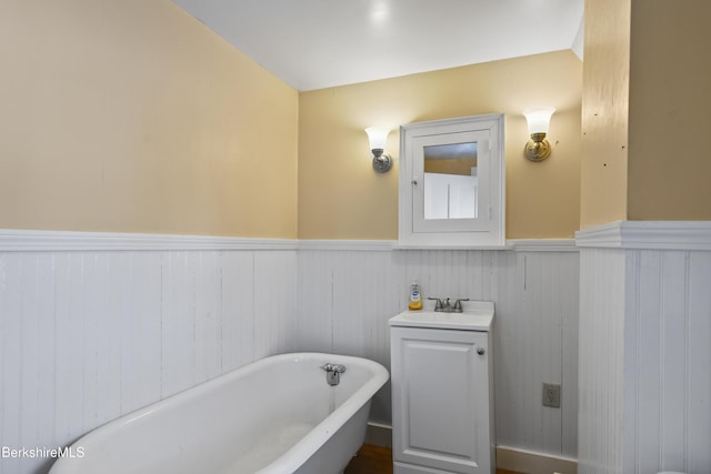 bathroom with vanity and a washtub