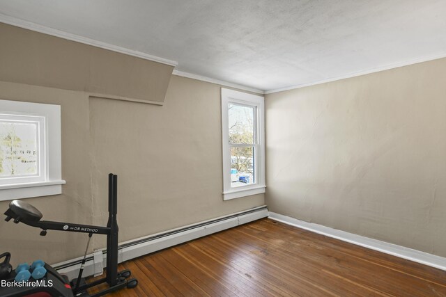 exercise area with dark wood-type flooring, ornamental molding, and a baseboard radiator