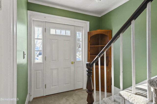 carpeted entrance foyer with ornamental molding