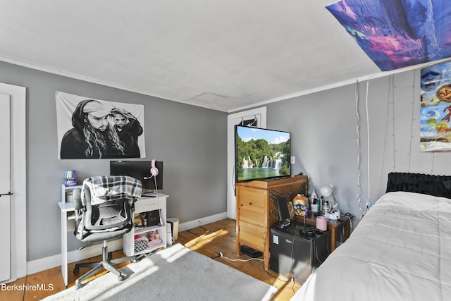 bedroom featuring crown molding and hardwood / wood-style flooring