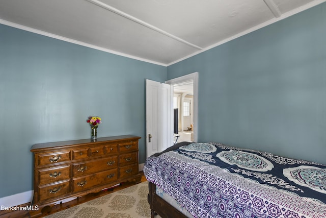 bedroom featuring crown molding and light hardwood / wood-style floors