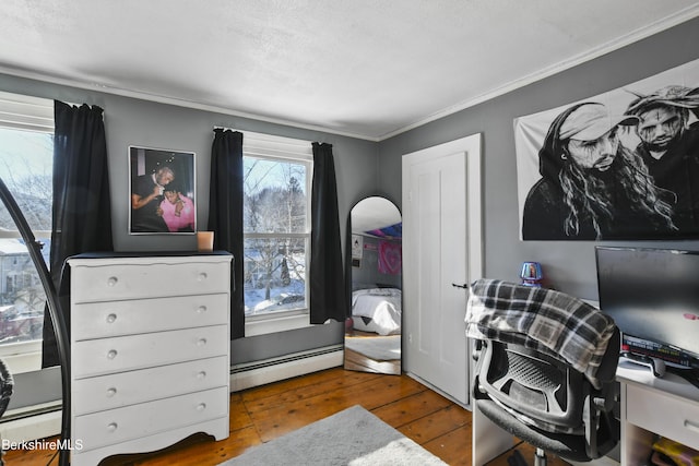 office with crown molding, wood-type flooring, and a baseboard radiator