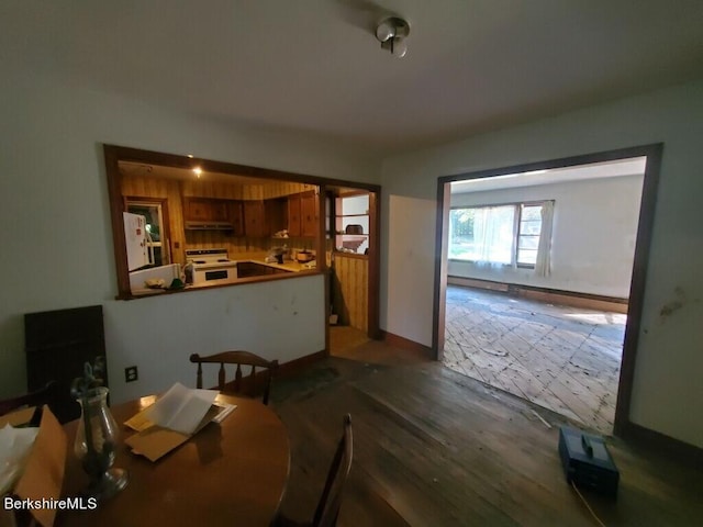 dining space with wood-type flooring