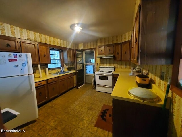 kitchen with white appliances and sink