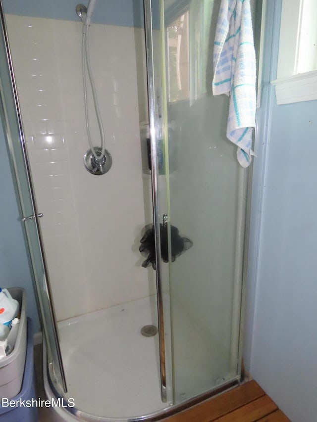 bathroom with toilet and a shower with door