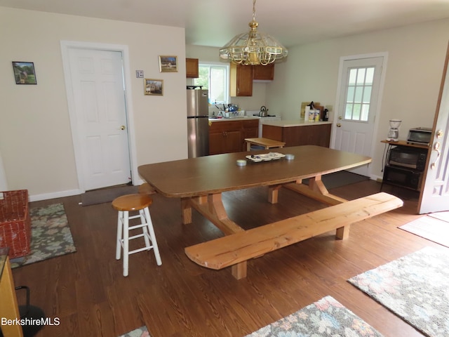 dining room featuring dark hardwood / wood-style floors and a chandelier