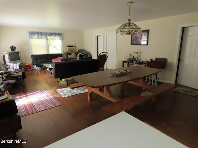 dining area featuring wood-type flooring and an inviting chandelier